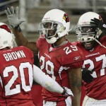 Arizona Cardinals Dominique Rodgers-Cromartie (29) celebrates with teammates Ralph Brown (20) and Michael Adams, right, after Rodgers-Cromartie made an interception against the Seattle Seahawks in the fourth quarter of an NFL football game Sunday, Dec. 28, 2008 in Glendale, Ariz. The Cardinals defeated the Seahawks 34-21. (AP Photo/Ross D. Franklin)