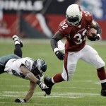 Arizona Cardinals running back Edgerrin James, right, carries the ball as Philadelphia Eagles safety Quintin Demps defends during the first half of the NFL NFC Championship football game Sunday, Jan. 18, 2009, in Glendale, Ariz. (AP Photo/David J. Phillip)