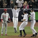 Philadelphia Phillies' Pedro Martinez, left, watches as New York Yankees' Derek Jeter, right, celebrates with teammate Johnny Damon after scoring on a hit by Hideki Matsui during the third inning of Game 6 of the Major League Baseball World Series Wednesday, Nov. 4, 2009, in New York. Yankees Jorge Posada, center, also celebrated. (AP Photo/Eric Gay)