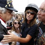 Sarah Palin, former GOP vice presidential candidate and Alaska governor, with her daughter Piper, center, answers a reporter's question at the beginning of Rolling Thunder at the Pentagon Sunday, May 29, 2011, during the Memorial Day weekend in Washington. (AP Photo/Alex Brandon)