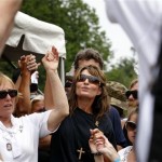 Former Alaska governor and vice presidential candidate Sarah Palin holds hands with people gathered for Memorial Day weekend events on the National Mall in Washington Sunday, May 29, 2011. Palin rode to the mall from the Pentagon with motorcyclists in the traditional annual Rolling Thunder rally. (AP Photo/Jose Luis Magana)
