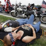 Shelly Pfennig, from Fayetteville, N.C., uses a bandana to help rest as she waits at the beginning of Rolling Thunder at the Pentagon in Washington Sunday, May 29, 2011, for the traditional annual Memorial Day weekend event. (AP Photo/Alex Brandon)