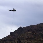 A search and rescue team helicopter carries 
out the body of a victim in the plane crash 
at the Superstition Mountains east of Apache 
Junction, Ariz, Thursday, Nov. 24, 2011. A 
small plane crashed there on Wednesday 
evening, killing all passengers on board, 
including a pilot father and his three 
children traveling for Thanksgiving. (AP 
Photo/The Arizona Republic, Nick Oza)