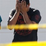 A man who said he had a child inside of the 
home where five people were shot Wednesday, May 
2, 2012 in Gilbert, Ariz. cries after talking 
with police as he walks inside the crime scene 
tape. (AP Photo/Matt York)