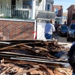 CNCS CEO Wendy Spencer looks at debris in front of a home being cleaned out by AmeriCorps members in Atlantic City, N.J. after Hurricane Sandy. High levels of volunteerism and civic engagement can lead to lower unemployment rates and stronger economic communities, Spencer says. (Photo: M. T. Harmon, Corporation for National and Community Service)
