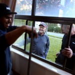 Denny Crouch watches as Frank Santana and T.J. Paswaters of Murray Glass install new windows in his Cottonwood Heights home on Friday, Oct. 24, 2014. Crouch is recently retired after 30 years at the University of Utah. (Photo: Laura Seitz, Deseret News)