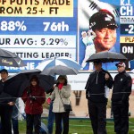 Fans, holding umbrellas, line up in front of the ninth hole during the second round of the Phoenix Open golf tournament, Friday, Jan. 30, 2015, in Scottsdale, Ariz. (AP Photo/Rick Scuteri)

