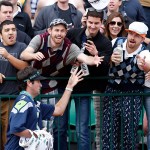 Bubba Watson hands out visors on the 16th hole during the third round of the Phoenix Open golf tournament, Saturday, Jan. 31, 2015, in Scottsdale, Ariz. (AP Photo/Rick Scuteri)
