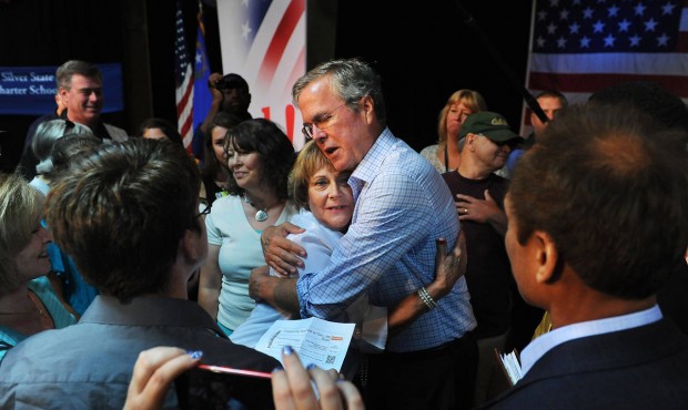 Republican presidential candidate Jeb Bush hugs Barbara Suber, of Sparks, Nev., following a town ha...