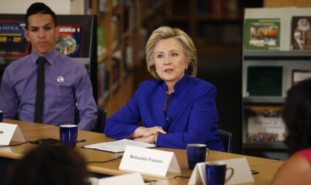 IN this May 5, 2015, photo, Hillary Rodham Clinton speaks with a group, including students, about i...