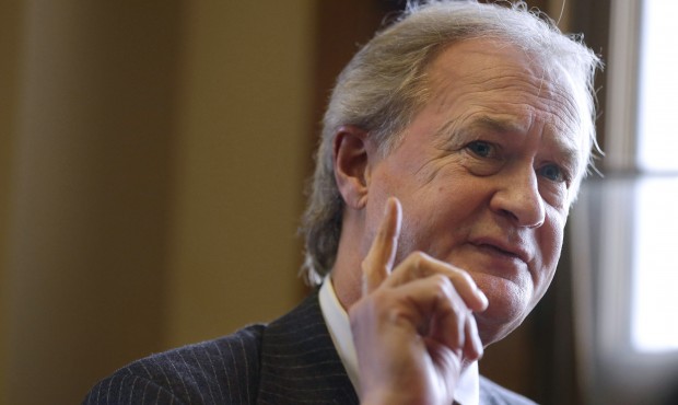 FILE – In this Dec. 11, 2014 file photo then-Rhode Island Gov. Lincoln Chafee responds to que...