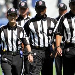 Line judge Shannon Eastin, left, takes the field prior to an NFL preseason football game between the San Diego Chargers and the Green Bay Packers, Thursday, Aug. 9, 2012, in San Diego. Eastin is a replacement line judge who will make her NFL debut in the exhibition game. The regular officials are locked out by the league after their contract expired. (AP Photo/Denis Poroy)