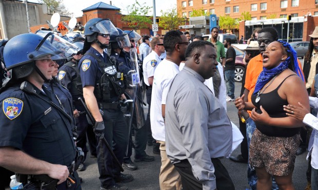 Protesters chant in front of police Monday, May 4, 2015, in Baltimore. Lt. Col. Melvin Russell said...