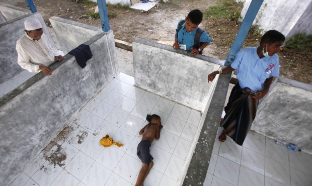 A Rohingya boy sleeps on the floor at a temporary shelter in Langsa, Aceh province, Indonesia, Thur...