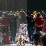               Visitors are reflected in the wall of the Vietnam Veterans Memorial in Washington, Sunday, May 25, 2014. (AP Photo/Molly Riley)
            