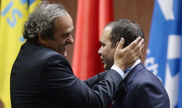 Prince Ali bin al-Hussein, right, with UEFA President Michel Platini, left, after announcing his wi...