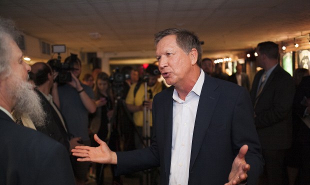 n Ohio Gov. John Kasich speaks to an audience member during an event during an event hosted by the ...