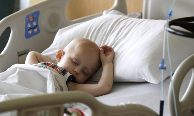 Landon Kimich, 2, sleeps as he receives a chemotherapy treatment for neuroblastoma at Houston&#8217...