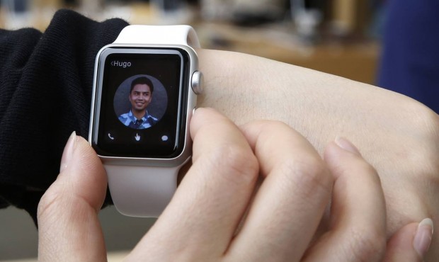 FILE – In this April 10, 2015, file photo, a customer tries on an Apple Watch at an Apple Sto...