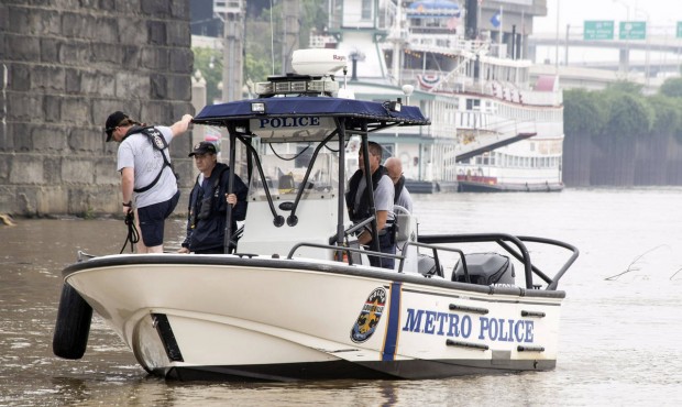 Authorities stand on a Louisville Metro Police Department boat, Sunday, July 5, 2015, on the Ohio R...