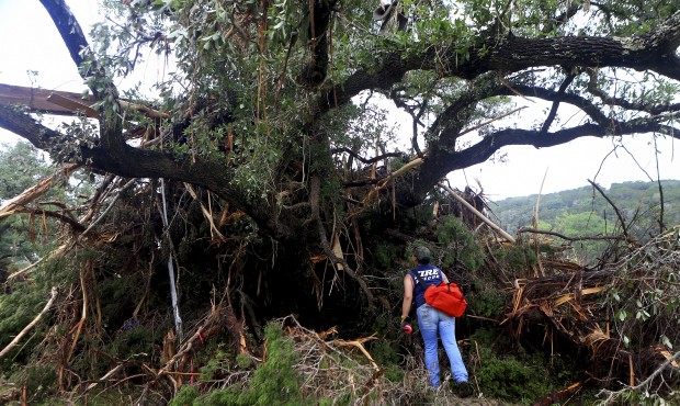 Alaena Tate, a member of a search and rescue team, looks through debris for people who were still m...