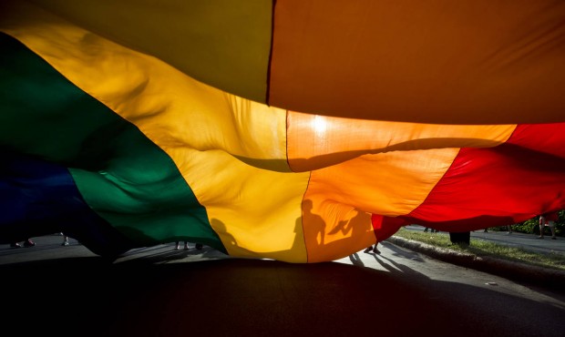 Members of the LGBT movement hold a gay pride flag during a parade celebration in Managua, Nicaragu...