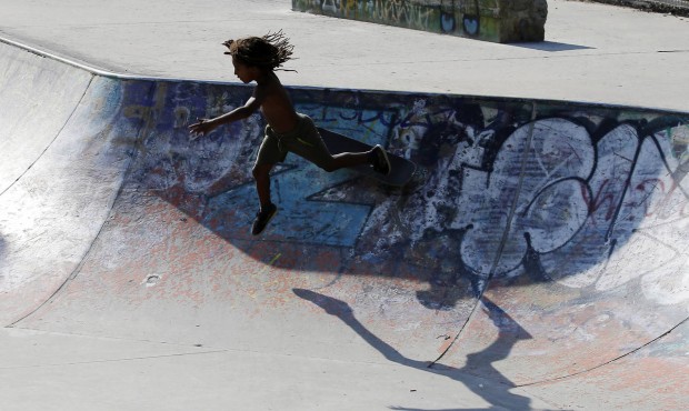 n In this July 9, 2015 photo, a young skater falls as he plays in a skate park in Milan, Italy. (AP...