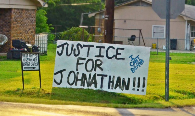 In this July 11, 2015 photograph, sign of support for Jonathan Sanders, a black man who is believed...
