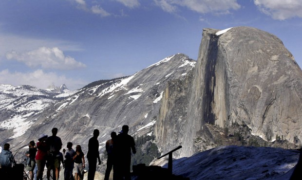 FILE – In this 2005 file photo, visitors view Half Dome from Glacier Point at Yosemite Nation...