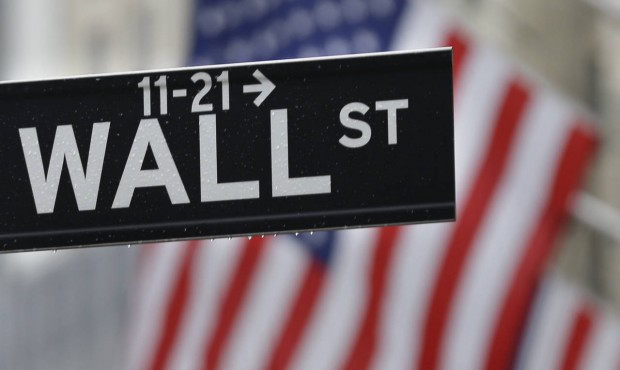 This July 9, 2015 photo shows a Wall Street sign near the New York Stock Exchange in New York. U.S....
