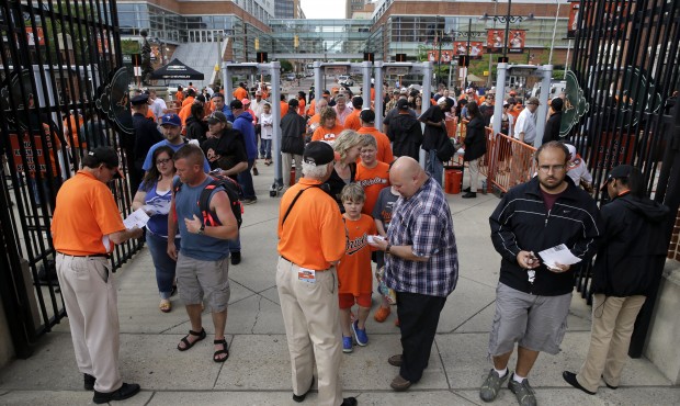 Ushers check fans’ tickets as they enter Orioles Park at Camden Yards before a baseball game ...