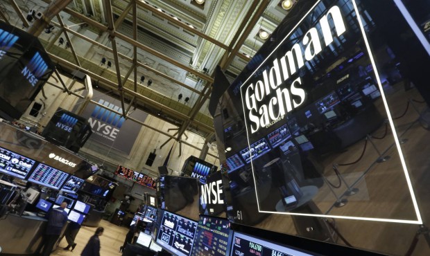 n FILE – In this Aug. 15, 2014, file photo, a lighted sign marks the Goldman Sachs trading po...