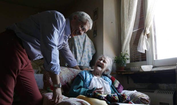 n In this Friday, June 26, 2015 photo, Emma Morano, 115, smiles at her physician, Carlo Bava, in he...
