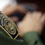 
              In this June 5, 2014 picture, a Border Patrol agent uses a headset and computer to conduct a long distance interview by video with a person arrested crossing the border in Texas, from a facility in San Diego. Hit with a dramatic increase of Central Americans crossing in South Texas, the Border Patrol is relieving staffing woes by enlisting agents in less busy sectors to process arrests through video interviews.  (AP Photo/Gregory Bull)
            