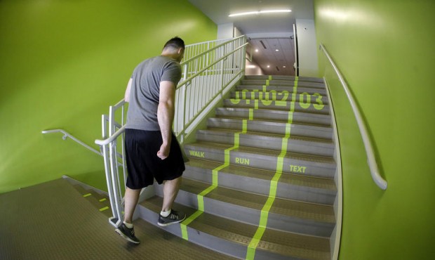 A Utah Valley University student walks up the bright green lanes painted on the stairs to the gym T...