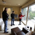               Janie Lee, right, a residential specialist with John L. Scott Real Estate, shows a home for sale to her client, Hongbin Wei, center, of Beijing, China, Thursday, Dec. 18, 2014, in Medina, Wash., near Seattle, as homeowner Doug Ebstyne looks on at left. Real estate agents such as Lee are taking note of growing connections linking China and Washington state, which ranks second to California in real estate sales to Chinese buyers. (AP Photo/Ted S. Warren)
            
