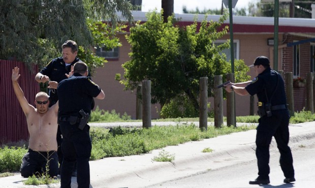 n This Saturday, July 18, 2015 photo shows police officers surrounding the suspect in a shooting in...