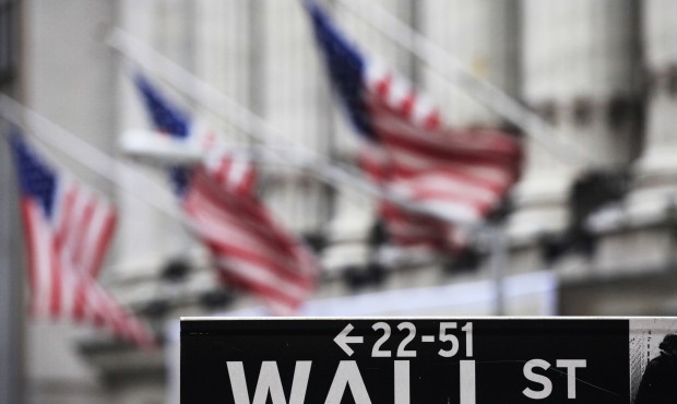 FILE – This April 22, 2010, file photo, shows a Wall Street sign in front of the New York Sto...