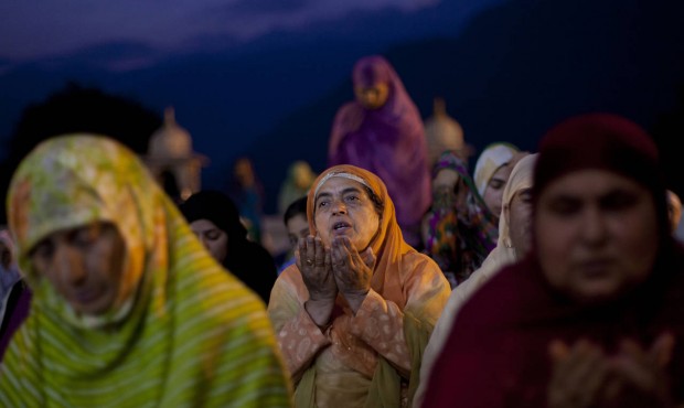 Kashmiri Muslim devotees pray early in the morning at the Hazratbal shrine, during special prayers ...
