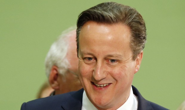 Britain’s Conservative party leader David Cameron walks around and talks to party officials a...