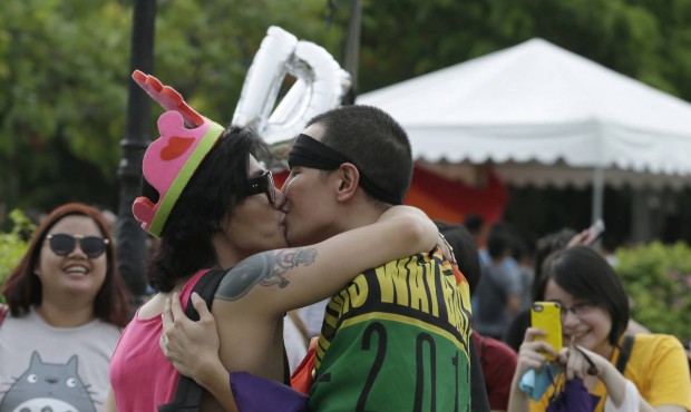 Filipino LGBTs (Lesbians Gays Bisexual and Transgenders) kiss as they gather for a Gay Pride rally ...