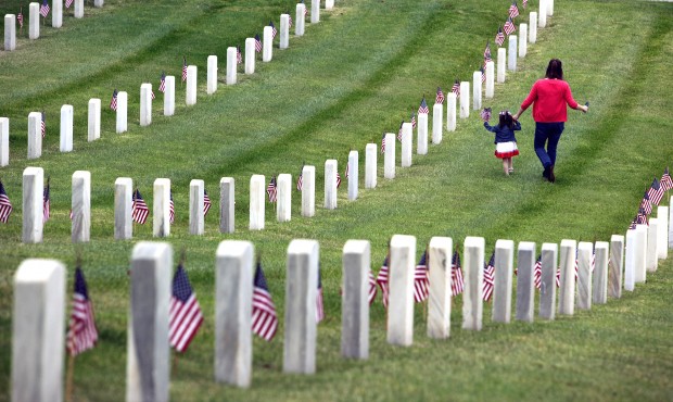 Katie Mcgaha, right, walks with Madelyn Andrews, of Woodland Hills, Calif., while placing flags at ...