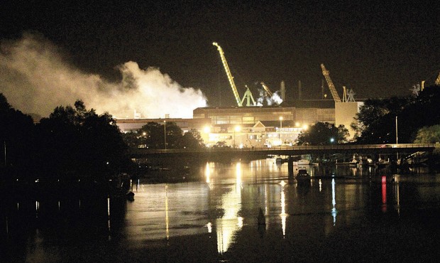 n FILE – In this Wednesday, May 23, 2012 file photo, smoke rises from a dry dock as fire crew...
