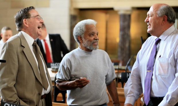 In this May 20, 2015, photo, Nebraska state Sen. Ernie Chambers, an independent, center, jokes with...