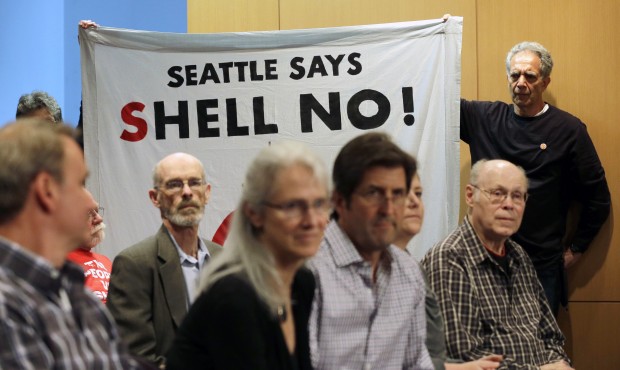 Protesters hold a sign opposing Shell Oil during a Seattle of the Port of Seattle Commission meetin...