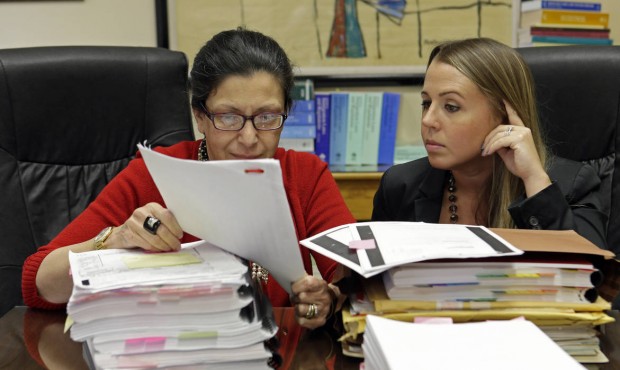 In this photo taken July 16, 2015, attorneys Grisel Ybarra, left, and Monica Barba Neumann look ove...