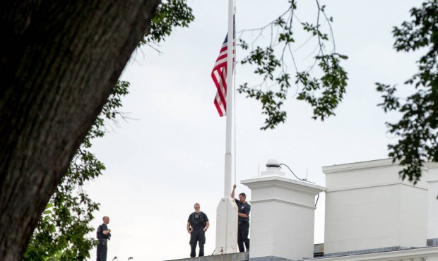 The American flag is lowered to half-staff above the White House in Washington, Tuesday, July 21, 2...