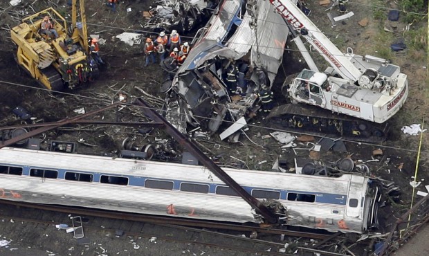Emergency personnel work at the scene of a deadly train wreck, Wednesday, May 13, 2015, in Philadel...