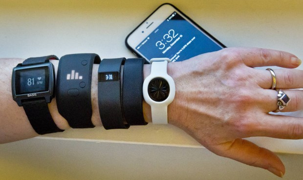 FILE – In this Dec. 15, 2014, file photo, fitness trackers, from left, Basis Peak, Adidas Fit...