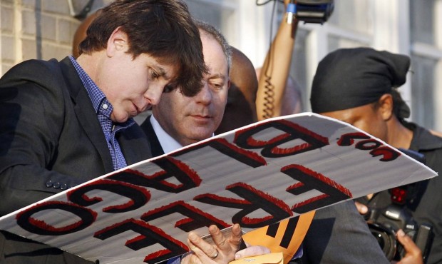 FILE – This March 14, 2012 file photo shows former Illinois Gov. Rod Blagojevich autographing...